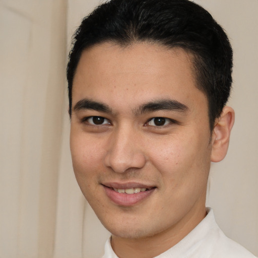 Joyful latino young-adult male with short  brown hair and brown eyes