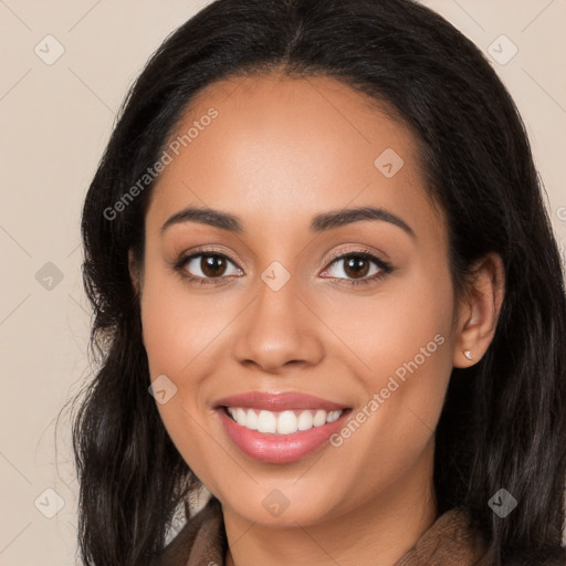 Joyful latino young-adult female with long  black hair and brown eyes