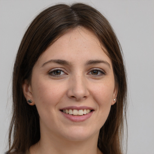 Joyful white young-adult female with long  brown hair and grey eyes