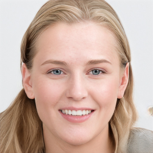 Joyful white young-adult female with long  brown hair and blue eyes