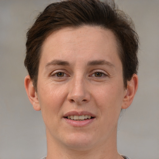 Joyful white adult female with short  brown hair and grey eyes