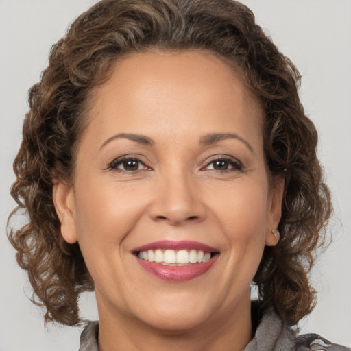 Joyful white adult female with medium  brown hair and brown eyes