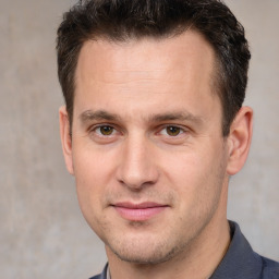 Joyful white young-adult male with short  brown hair and brown eyes