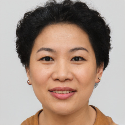 Joyful asian young-adult female with short  brown hair and brown eyes