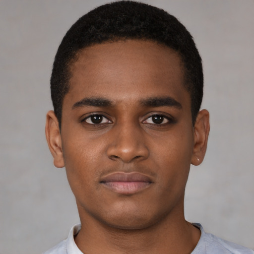 Joyful black young-adult male with short  black hair and brown eyes