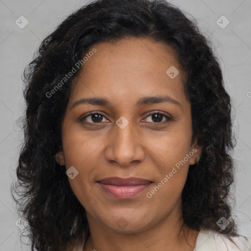 Joyful black young-adult female with long  brown hair and brown eyes