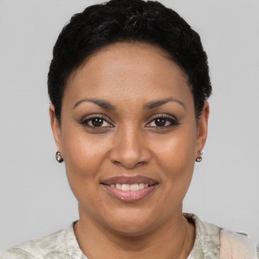 Joyful latino young-adult female with short  black hair and brown eyes