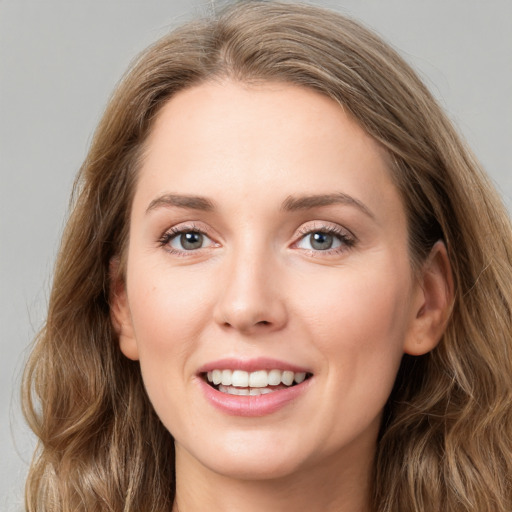 Joyful white young-adult female with long  brown hair and green eyes