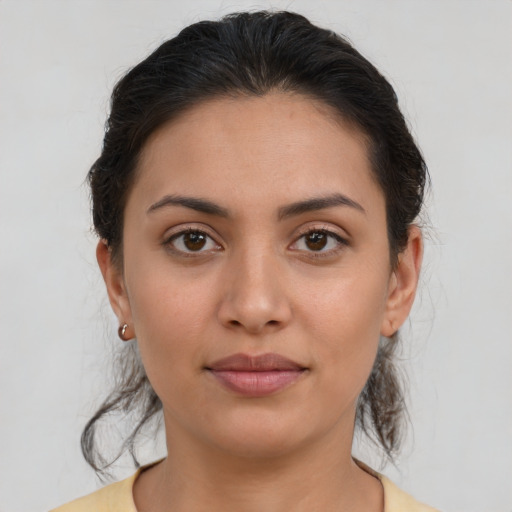 Joyful latino young-adult female with medium  brown hair and brown eyes