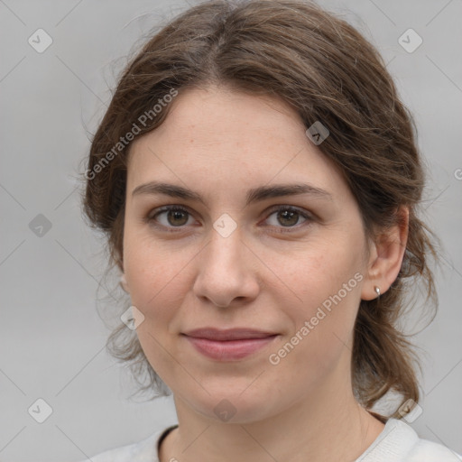 Joyful white young-adult female with medium  brown hair and grey eyes