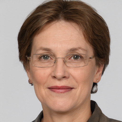 Joyful white middle-aged female with medium  brown hair and grey eyes