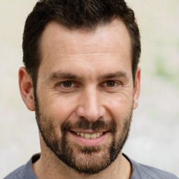 Joyful white adult male with short  brown hair and brown eyes