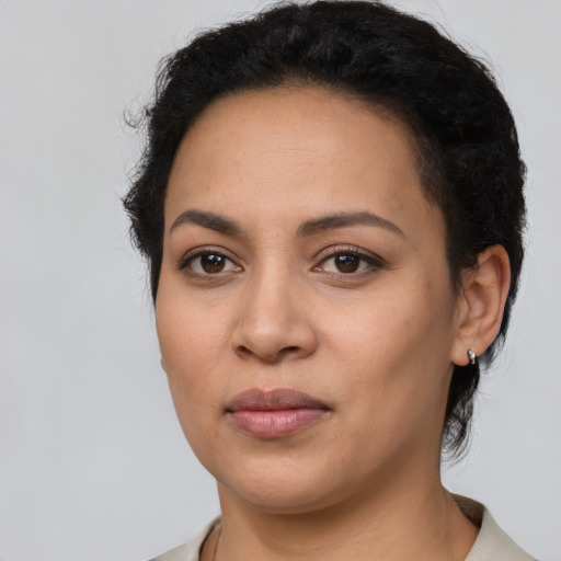 Joyful latino young-adult female with short  brown hair and brown eyes