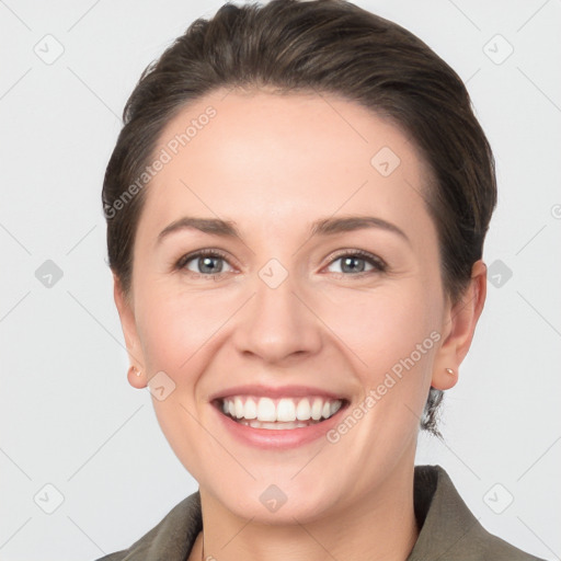 Joyful white young-adult female with short  brown hair and grey eyes