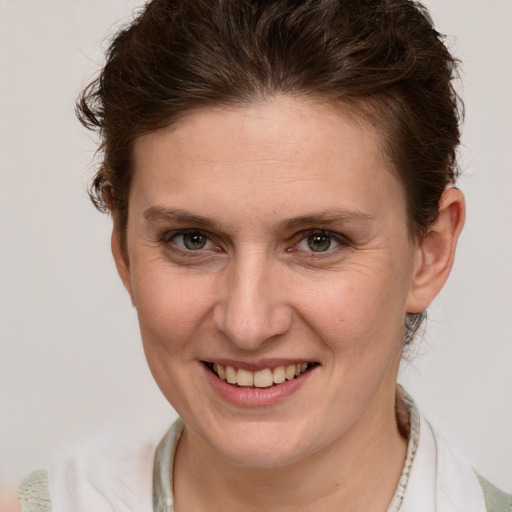 Joyful white young-adult female with short  brown hair and brown eyes