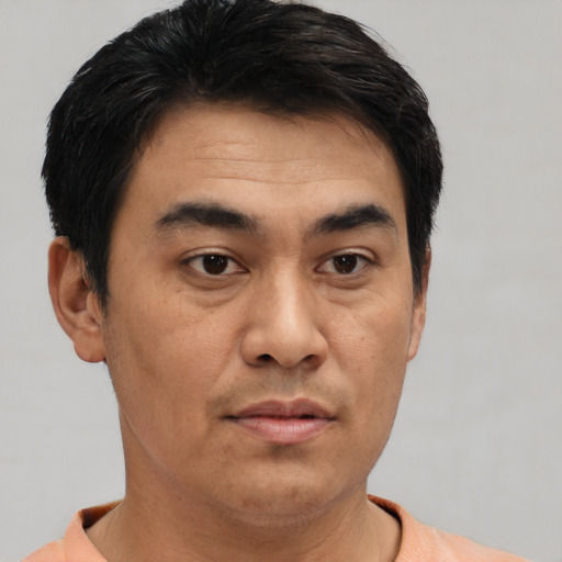 Neutral asian adult male with short  brown hair and brown eyes