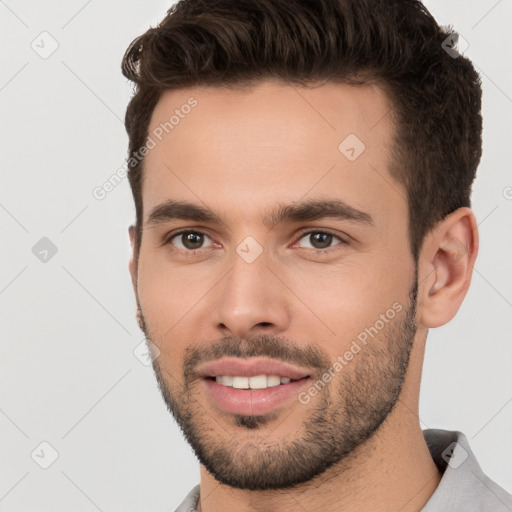 Joyful white young-adult male with short  brown hair and brown eyes