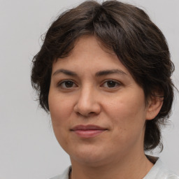 Joyful white adult female with medium  brown hair and brown eyes