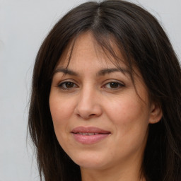 Joyful white adult female with long  brown hair and brown eyes