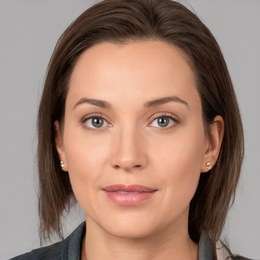 Joyful white young-adult female with medium  brown hair and grey eyes