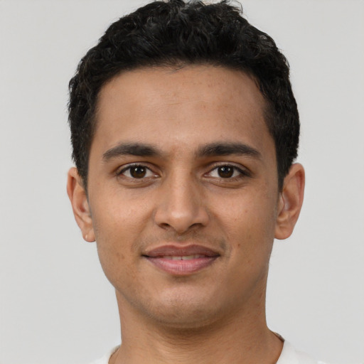 Joyful latino young-adult male with short  brown hair and brown eyes