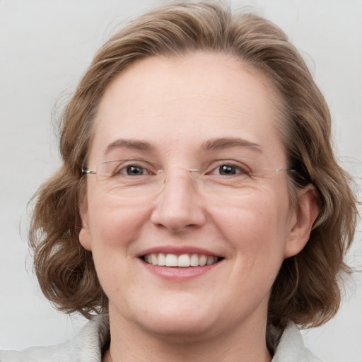 Joyful white young-adult female with medium  brown hair and blue eyes