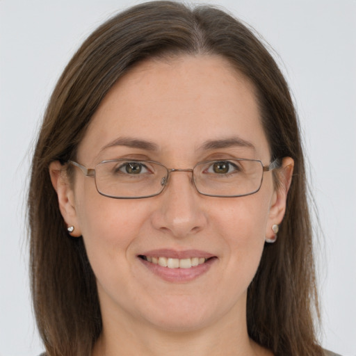 Joyful white adult female with long  brown hair and grey eyes