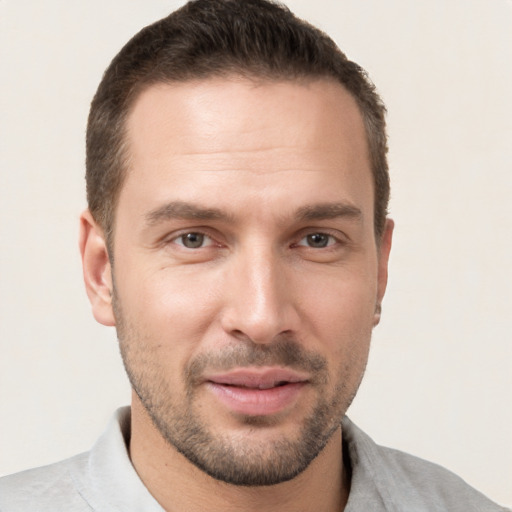 Joyful white young-adult male with short  brown hair and brown eyes