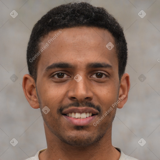 Joyful black young-adult male with short  brown hair and brown eyes