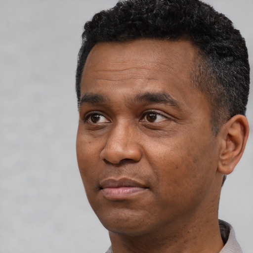 Neutral black adult male with short  black hair and brown eyes