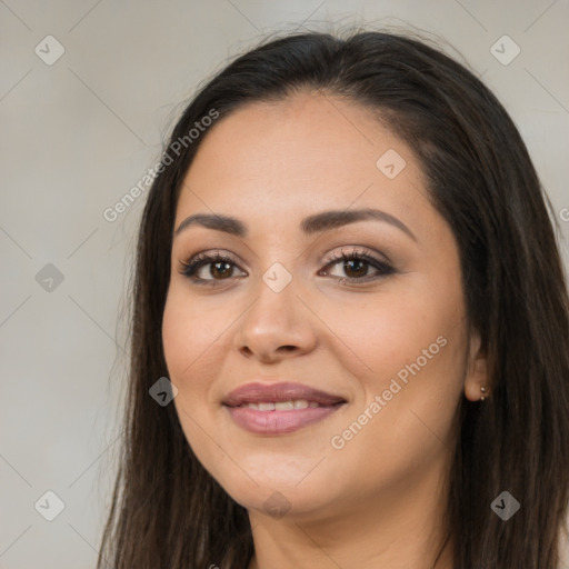 Joyful latino young-adult female with long  brown hair and brown eyes