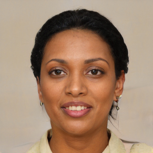 Joyful black young-adult female with medium  black hair and brown eyes