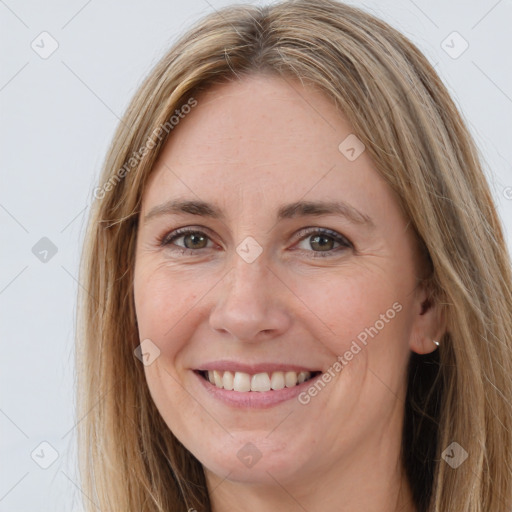 Joyful white adult female with long  brown hair and brown eyes