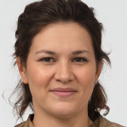 Joyful white adult female with medium  brown hair and brown eyes