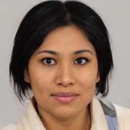 Joyful asian young-adult female with medium  brown hair and brown eyes