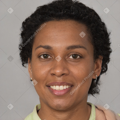 Joyful black adult female with short  brown hair and brown eyes