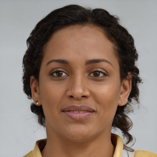 Joyful black young-adult female with medium  brown hair and brown eyes