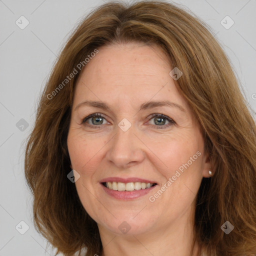 Joyful white adult female with long  brown hair and brown eyes