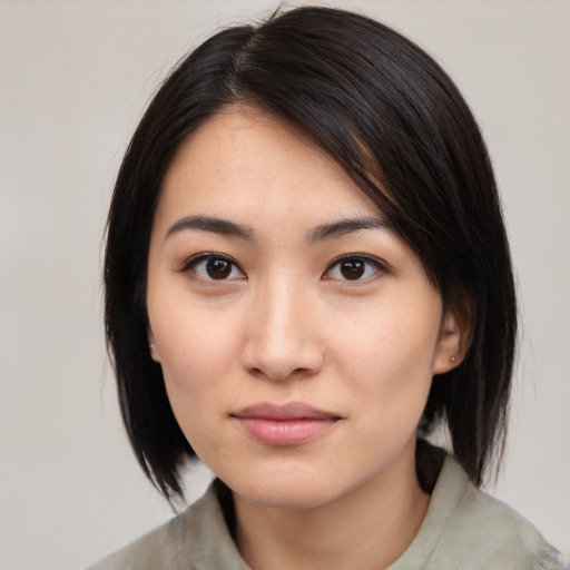 Joyful white young-adult female with medium  black hair and brown eyes