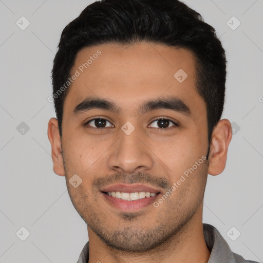 Joyful latino young-adult male with short  black hair and brown eyes