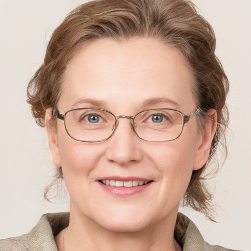 Joyful white adult female with medium  brown hair and blue eyes