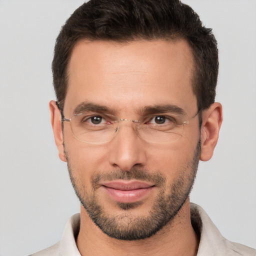 Joyful white adult male with short  brown hair and brown eyes