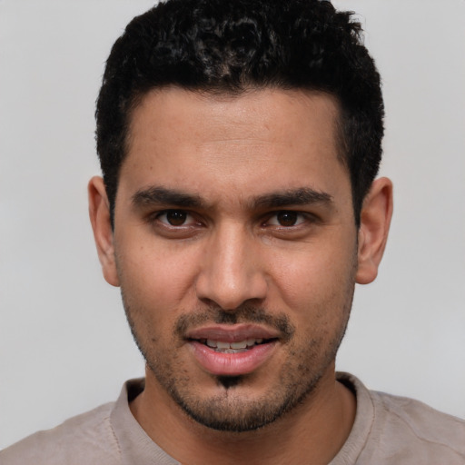 Joyful white young-adult male with short  black hair and brown eyes
