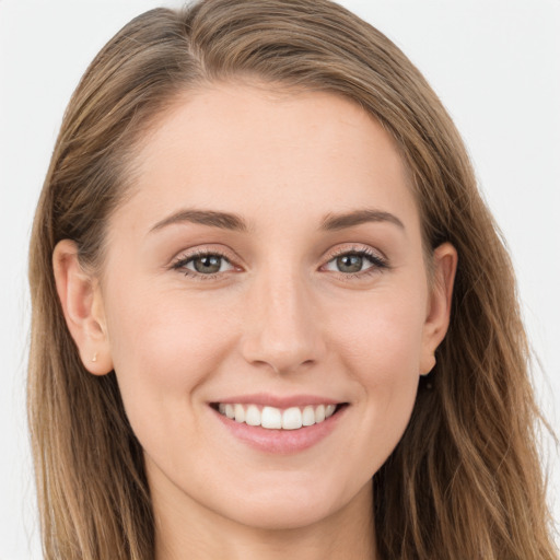 Joyful white young-adult female with long  brown hair and grey eyes