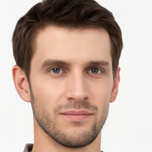 Joyful white young-adult male with short  brown hair and grey eyes