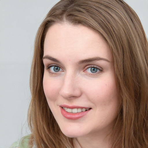 Joyful white young-adult female with long  brown hair and blue eyes