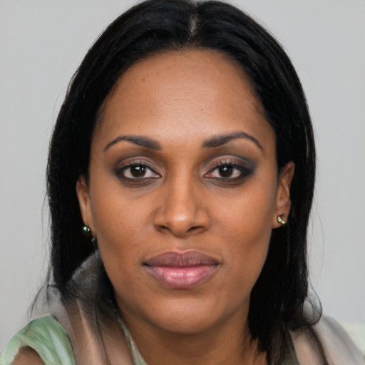 Joyful black young-adult female with medium  black hair and brown eyes