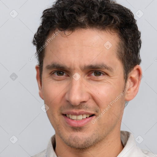 Joyful white adult male with short  brown hair and brown eyes