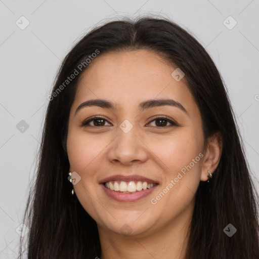 Joyful latino young-adult female with long  brown hair and brown eyes