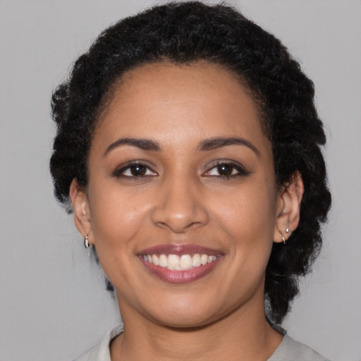Joyful latino young-adult female with medium  black hair and brown eyes